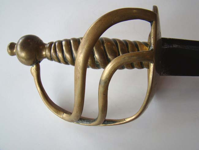 An 18th century English Grenadiers' Basket Hilted Hanger made by Samuel Harvey circa 1750-1768 with engraved heart shaped guard inscribed "M CHESHIRE" and having the Regimental markings 7 and 61.